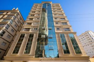 a tall building with a lot of windows at Apto moderno c/vista mar em Porto Belo SC MRE801 in Porto Belo