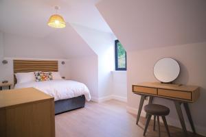 a bedroom with a bed and a desk with a mirror at Lowwood Lodges in Houston +57 photos