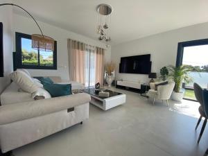 a living room with a couch and a table at Maison avec piscine in Agay - Saint Raphael