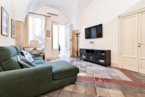 a living room with a couch and a flat screen tv at Corte del Fanfulla - Lecce Selection in Lecce +31 photos