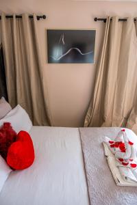 a white bed with a red stuffed animal on it at Dolce Vita, Spa, Cagnes Sur Mer in Cagnes-sur-Mer +5 photos