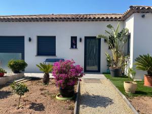 a house with flowers in front of a door at Maison avec piscine in Agay - Saint Raphael