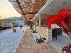 a building with a red flower on the side of it at Rousis's Manor House in Parga
