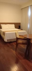Cama ou camas em um quarto em Grande Hotel Amparo