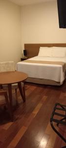Cama ou camas em um quarto em Grande Hotel Amparo