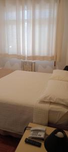 Cama ou camas em um quarto em Grande Hotel Amparo