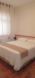 Cama ou camas em um quarto em Grande Hotel Amparo