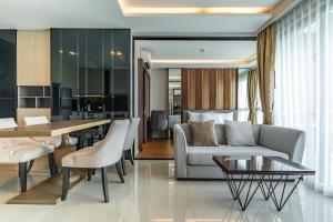 a living room with a couch and a table at Panora Condo by Villacarte in Surin Beach