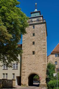 a building with a tower with a lighthouse on top at Boutique- und Businesshotel Herrenküferei in Markgröningen +21 photos