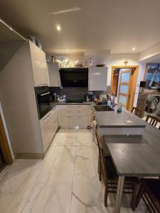 a kitchen with white cabinets and a table and a counter at Fomed in Brussels