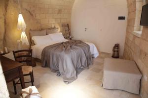 een slaapkamer met een bed met een deken erop bij Fondo Vito in Gravina in Puglia