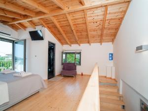 a bedroom with a bed and a wooden ceiling at Dea's home in Himare