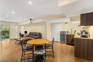 a kitchen and living room with a table and chairs at Cozy 1-BR, with Private Patio in Vaughan +7 photos