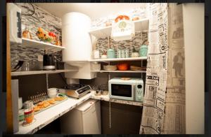 a small kitchen with a microwave on a counter at Bliss ' n joys in Montauroux