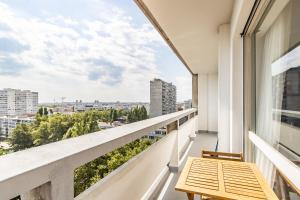 a balcony with a table and a view at T1 Confort Tête d'Or Doua - Parking Gratuit in Villeurbanne