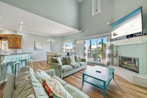 a living room with a couch and a fireplace at Lagoon Luxury in Gulf Shores