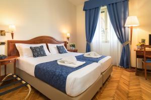 Postel nebo postele na pokoji v ubytování Hotel Galeazzi