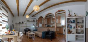 a living room with a couch and a table at Casa Rural Exedra 3 Estrellas in Carcaboso