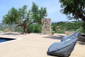 a blue bean bag chair sitting next to a pool at Modone Villas in Peloponnese in Methoni +97 photos