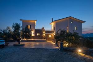 a large house at night with lights at Modone Villas in Peloponnese in Methoni