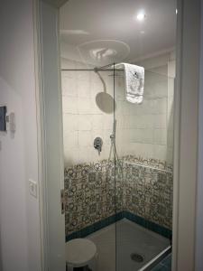 a shower with a glass door in a bathroom at Hotel America in Marina di Camerota