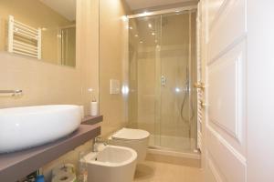 a bathroom with a shower and a sink and a toilet at Felix House in Savona