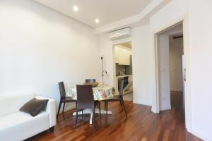 a living room with a table and chairs and a couch at Felix House in Savona +4 photos