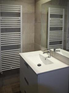 a bathroom with a white sink and a mirror at Casa Uva Republica Argentina 11 Logroño in Logroño