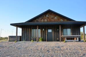 a building with a bench in front of it at Hot Tub & Panoramic Views Bear Butte &Buffalo Chip in Sturgis