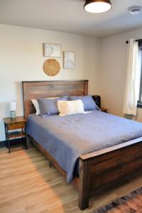 a bedroom with a large bed with a wooden headboard at Hot Tub & Panoramic Views Bear Butte &Buffalo Chip in Sturgis