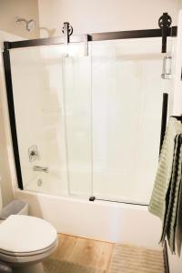 a bathroom with a shower and a toilet at Hot Tub & Panoramic Views Bear Butte &Buffalo Chip in Sturgis +23 photos