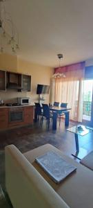 a living room with a table and a dining room at The Place - Splendido bilocale in centro con box auto in Civitanova Marche