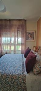 a bedroom with a bed with pillows and a window at The Place - Splendido bilocale in centro con box auto in Civitanova Marche