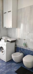a bathroom with a washing machine and a toilet at The Place - Splendido bilocale in centro con box auto in Civitanova Marche +19 photos