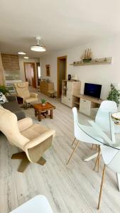 a living room with a couch and chairs at Luxury Family Levante Beach in Benidorm
