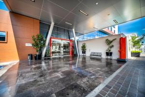 an empty lobby of a building with a red door at Metria Hotel in León