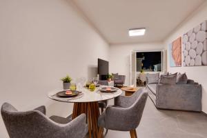 a living room with a table and chairs at Sea Front Luxury Apartment in Larnaka +10 photos