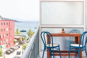 two chairs and a table on a balcony with a view at Himara City 33 - Central, Beach Access in Himare