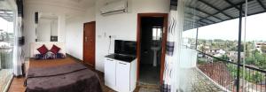a bedroom with a bed and a balcony at Luxury 1 Bed Room Suite in Boralesgamuwa