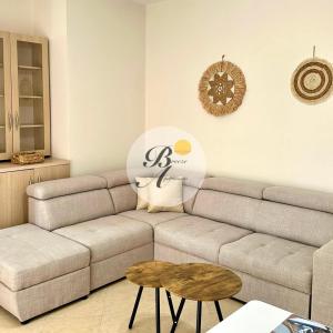 a living room with a couch and a table at Breeze Home in Vlorë