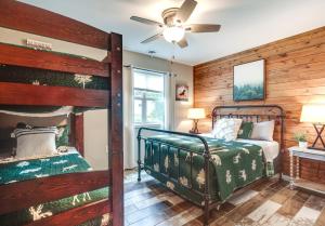 a bedroom with two bunk beds and a ceiling fan at Tranquil Lakefront Cabin Fire Pit, Grill and Patio in Tomahawk