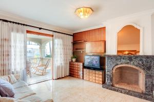a living room with a fireplace and a television at Vallespir in Port d'Alcudia +15 photos