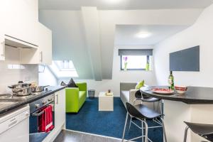 a kitchen and living room with a table and chairs at Destiny Student – Shrubhill (Campus Accommodation) in Edinburgh