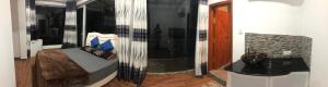 a room with a bed with a glass wall at Amaze Residence Panoramic Room 2 in Boralesgamuwa