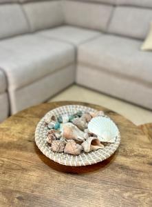 a bowl of rocks and shells on a table at Breeze Home in Vlorë