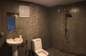 a bathroom with a toilet and a sink at Amaze Residence Panoramic Room 3 in Boralesgamuwa +15 photos