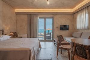 a hotel room with a bed and a view of the ocean at Skyros Trias in Skiros +144 photos