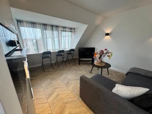 a living room with a couch and a table at Homes by the C in Zandvoort