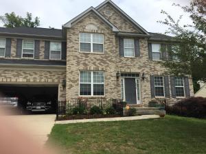 a large brick house with a car garage at Two bedroom apartment in single family home in Fort Washington