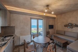 a kitchen and living room with a table and a couch at Skyros Trias in Skiros